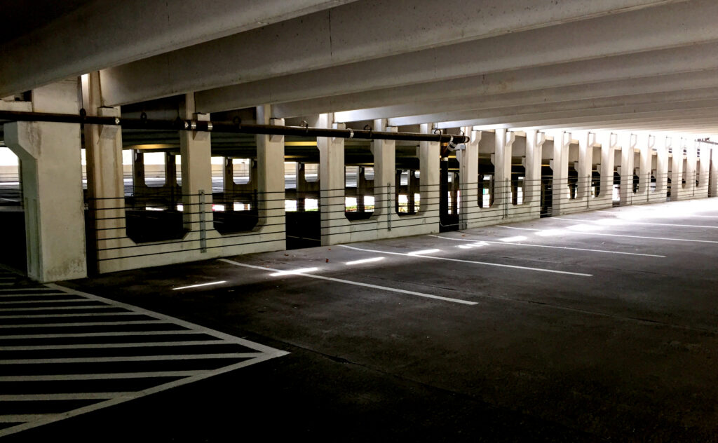 A partially enclosed vehicle parking structure that is empty.