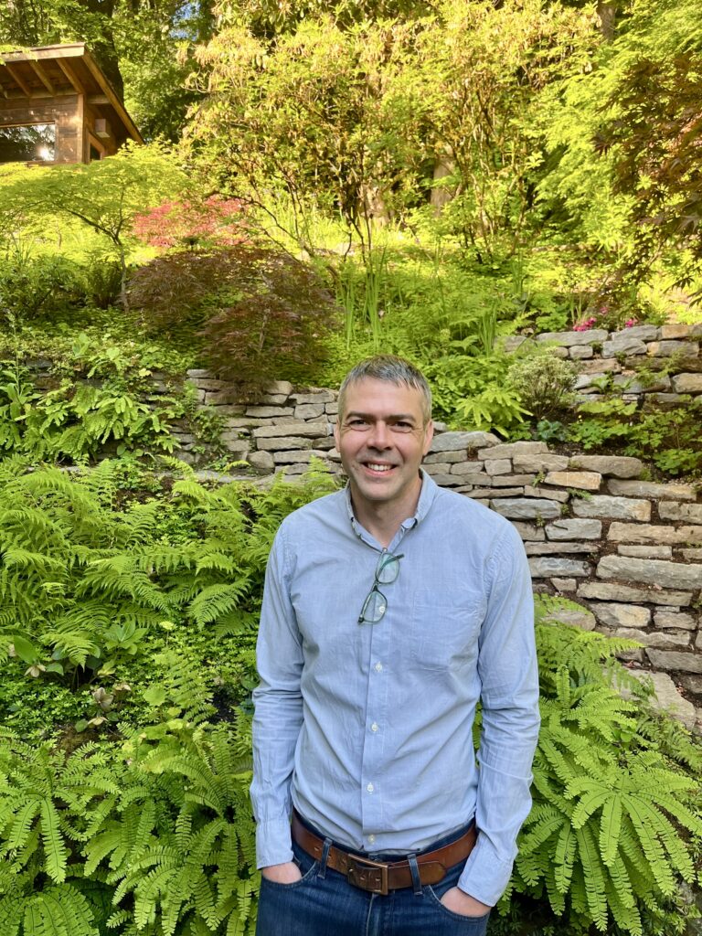 Picture of Aaron Antrim against a garden background
